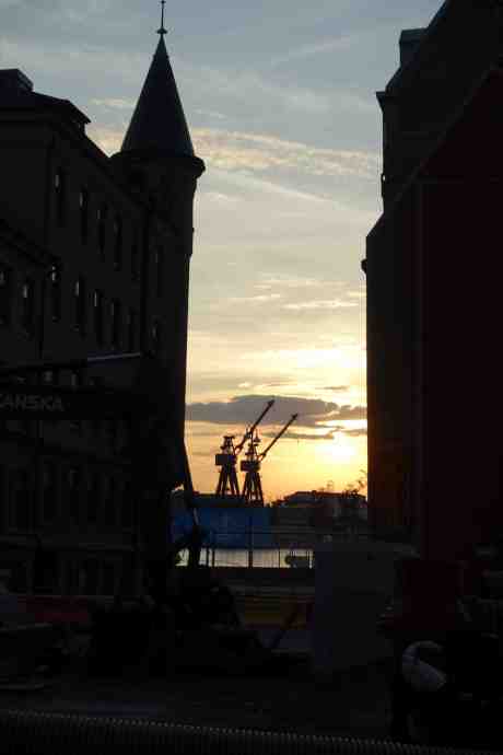 Götaverkens kranar på andra sidan Göta älv sedda genom Bryggaregatan. Från Stora Badhusgatan lördag 2 augusti 2014 kl 20:45.